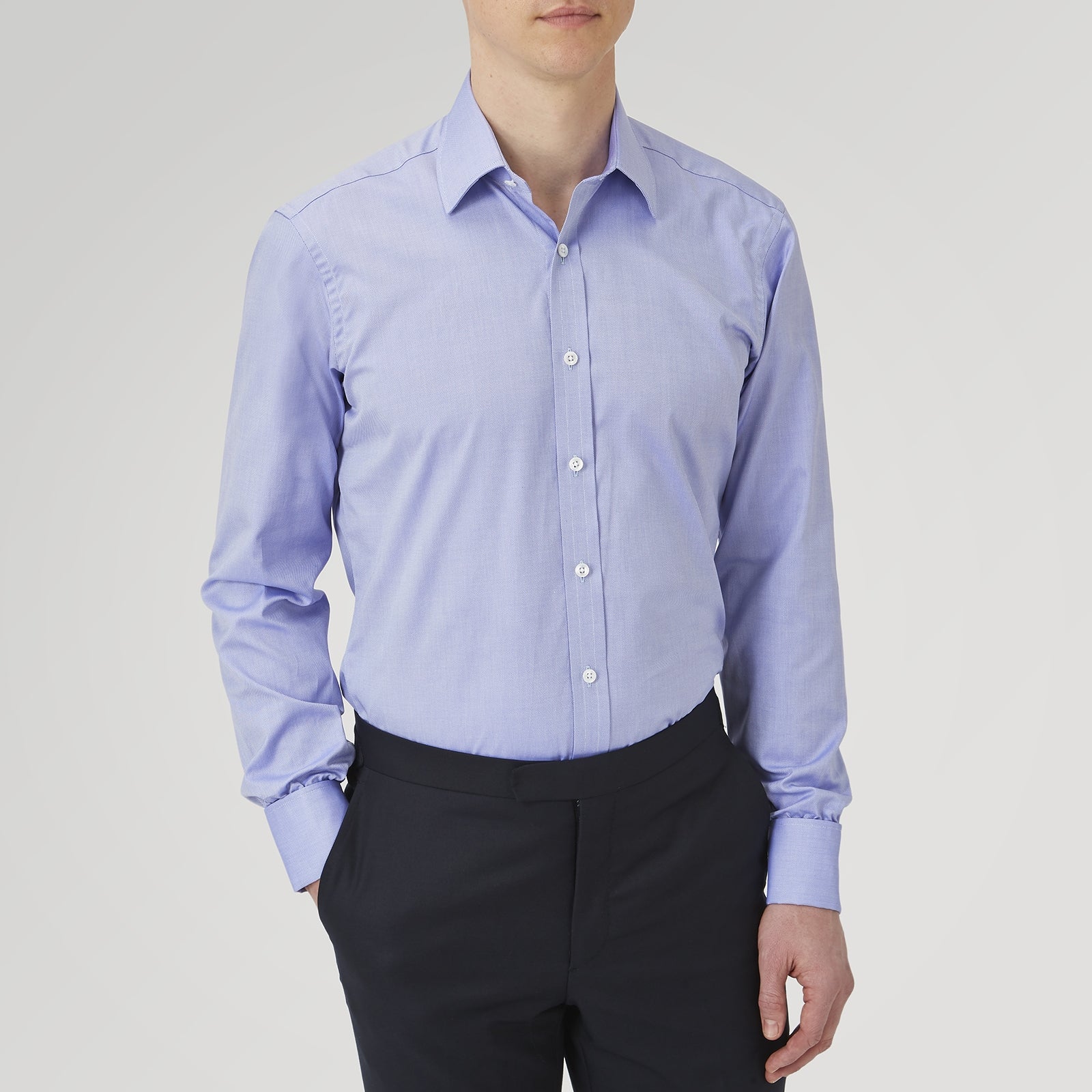 View 2 of product A Pink Superfine Oxford Cotton Shirt by Turnbull & Asser, featuring a T&A collar, double cuffs, and white buttons, is neatly folded and displayed against a plain white background.