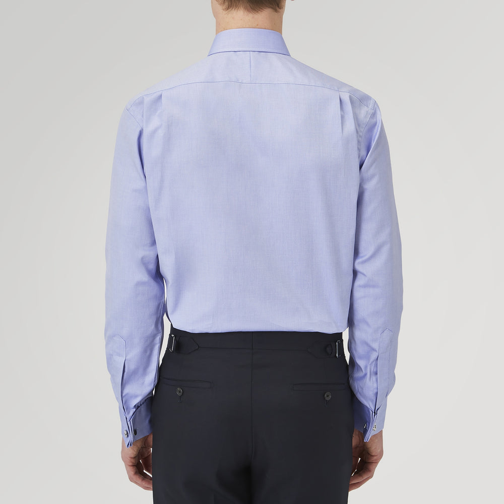 A Pink Superfine Oxford Cotton Shirt by Turnbull & Asser, featuring a T&A collar, double cuffs, and white buttons, is neatly folded and displayed against a plain white background.
