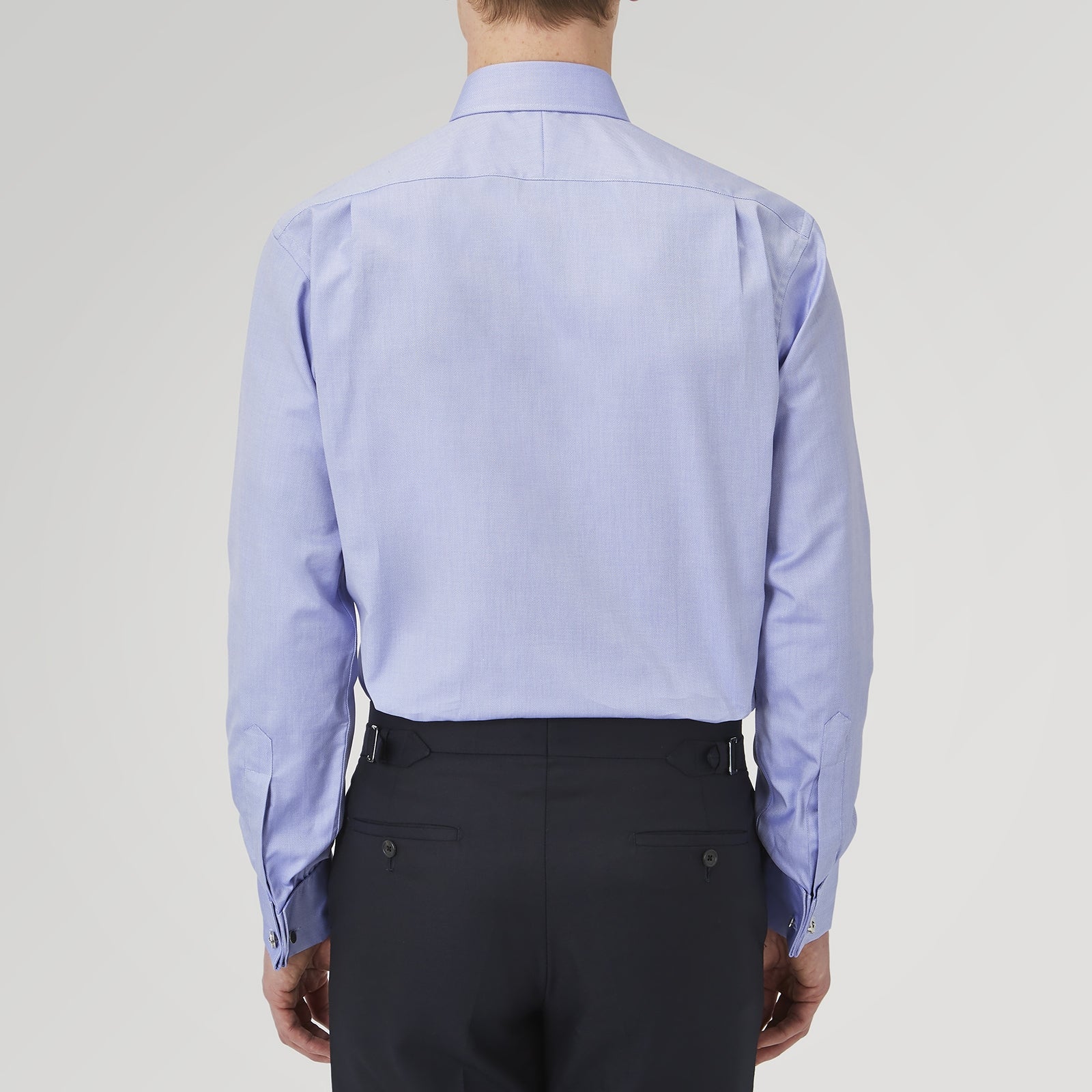 View 3 of product A Pink Superfine Oxford Cotton Shirt by Turnbull & Asser, featuring a T&A collar, double cuffs, and white buttons, is neatly folded and displayed against a plain white background.