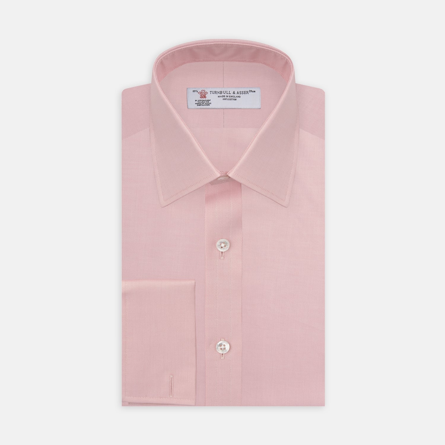 View 1 of product The Turnbull & Asser Pink Superfine Oxford Cotton Shirt features a T&A collar, double cuffs, and white buttons, neatly folded against a plain white background.