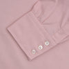 View 4 of product The Turnbull & Asser Pink Superfine Oxford Cotton Shirt features a T&A collar, double cuffs, and white buttons, neatly folded against a plain white background.