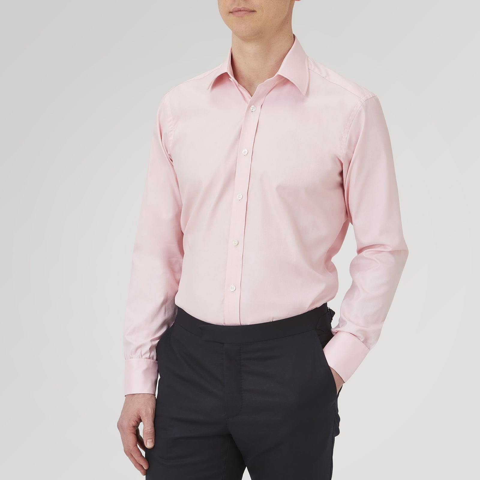 View 2 of product The Turnbull & Asser Pink Superfine Oxford Cotton Shirt features a T&A collar, double cuffs, and white buttons, neatly folded against a plain white background.