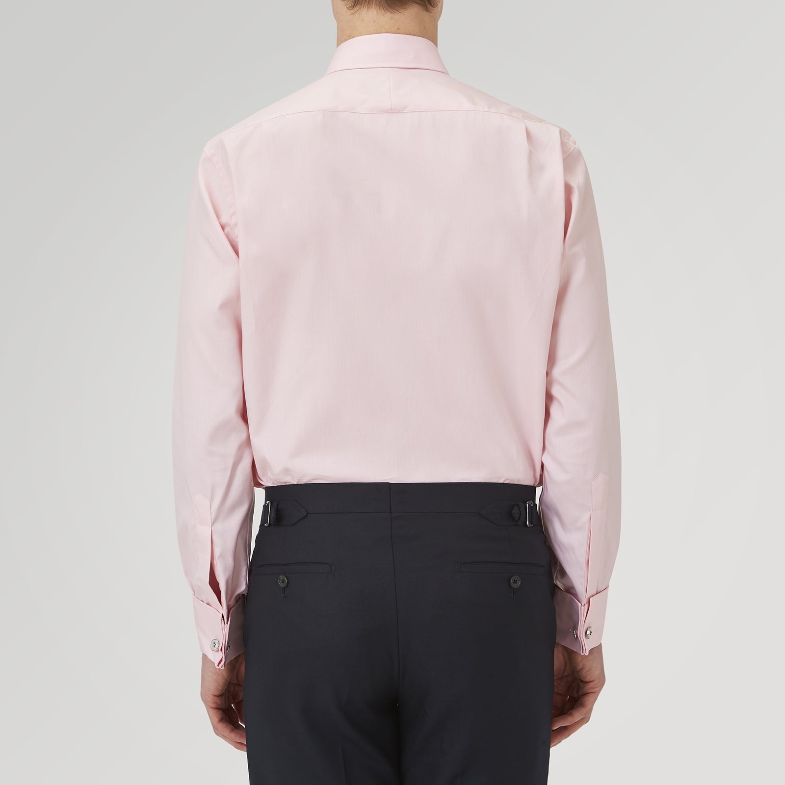 View 3 of product The Turnbull & Asser Pink Superfine Oxford Cotton Shirt features a T&A collar, double cuffs, and white buttons, neatly folded against a plain white background.