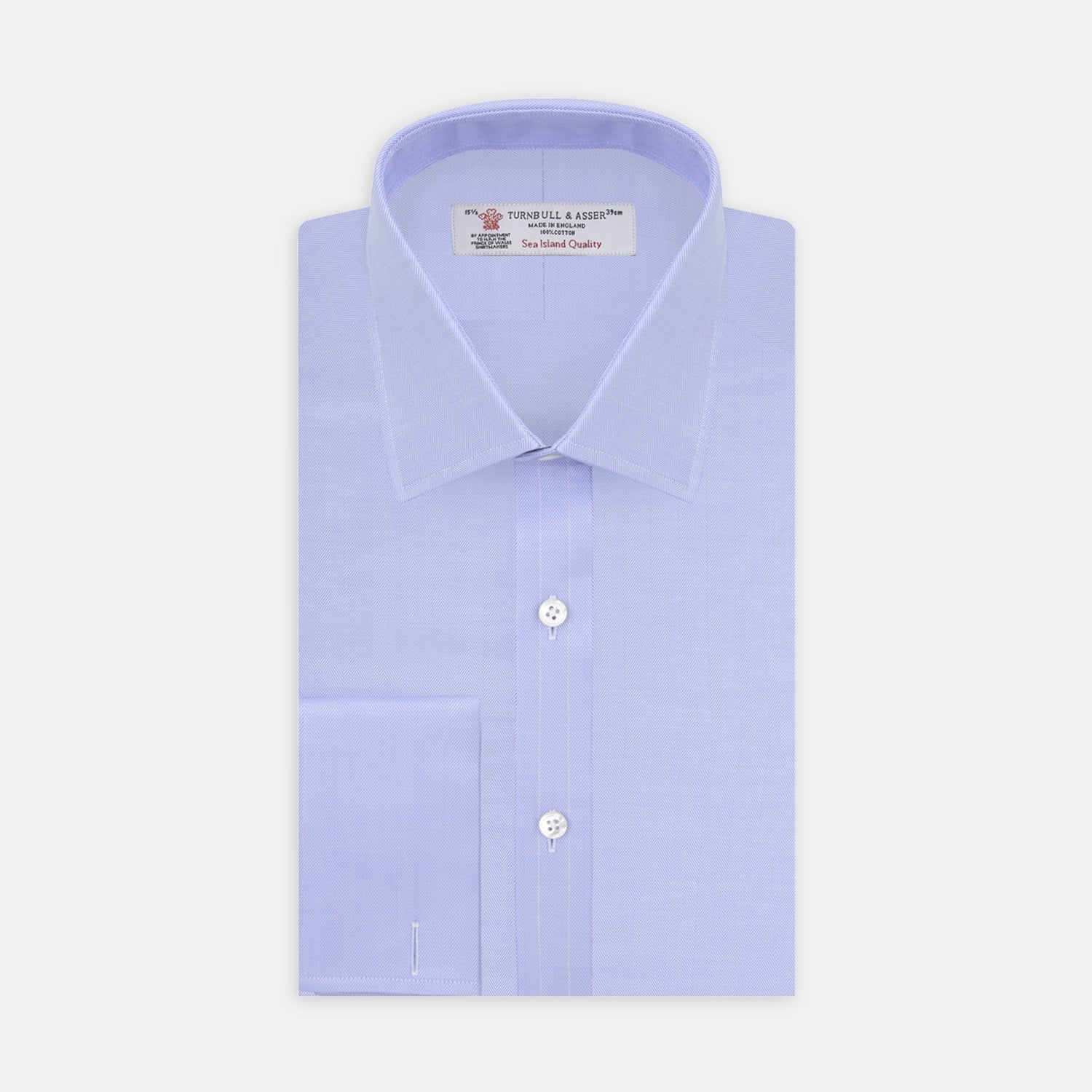 View 1 of product A Turnbull & Asser Light Blue Herringbone Sea Island Quality Cotton Shirt with T&A collar and double cuffs is neatly folded, label visible, and displayed against a plain white background.