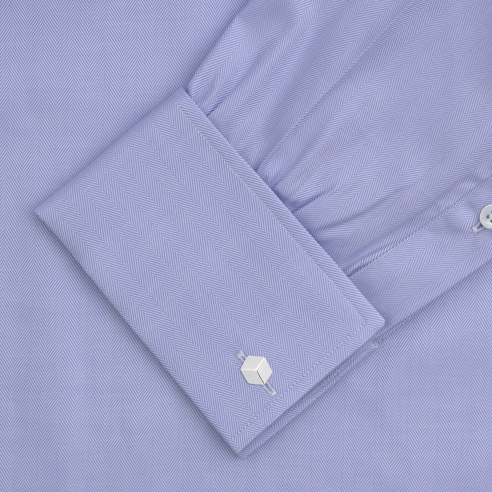 A Turnbull & Asser Light Blue Herringbone Sea Island Quality Cotton Shirt with T&A collar and double cuffs is neatly folded, label visible, and displayed against a plain white background.