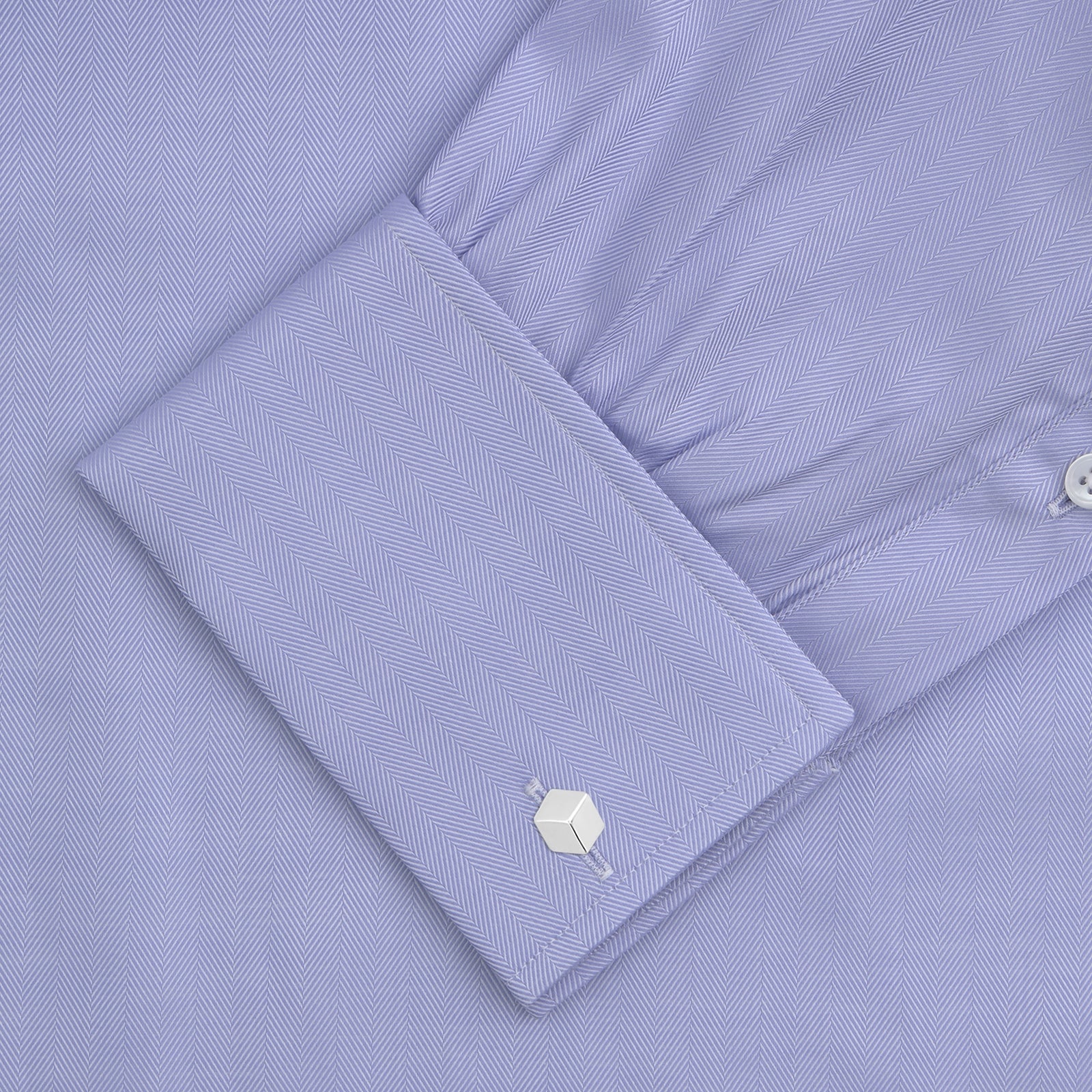 View 4 of product A Turnbull & Asser Light Blue Herringbone Sea Island Quality Cotton Shirt with T&A collar and double cuffs is neatly folded, label visible, and displayed against a plain white background.