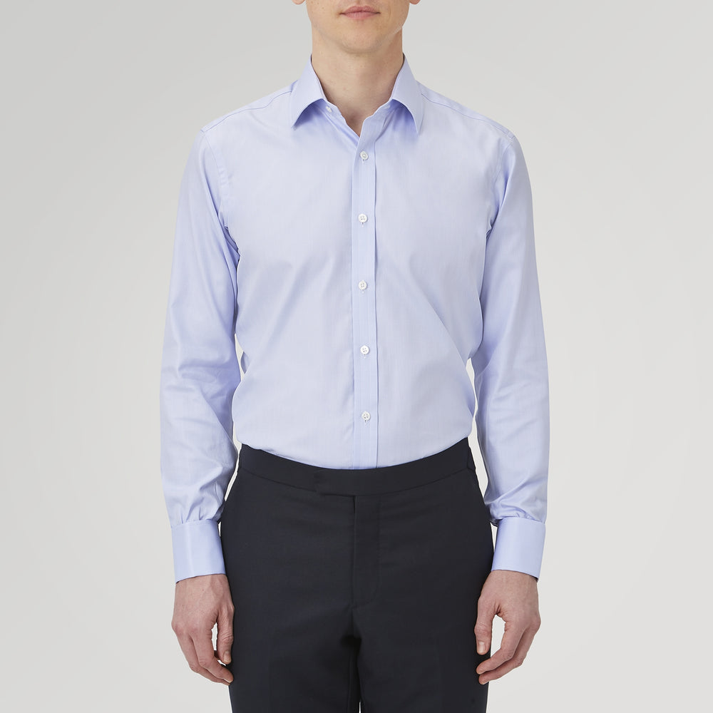 A Turnbull & Asser Light Blue Herringbone Sea Island Quality Cotton Shirt with T&A collar and double cuffs is neatly folded, label visible, and displayed against a plain white background.