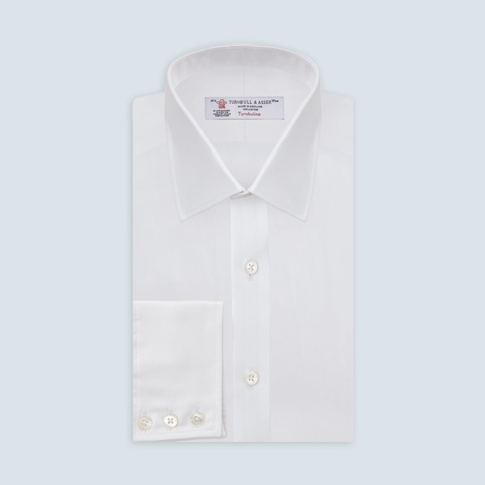 The Turnbull & Asser White Superfine Oxford Cotton Shirt features a T&A collar and 3-button cuffs, elegantly displayed against a light grey background.