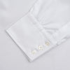 View 4 of product The Turnbull & Asser White Superfine Oxford Cotton Shirt features a T&A collar and 3-button cuffs, elegantly displayed against a light grey background.