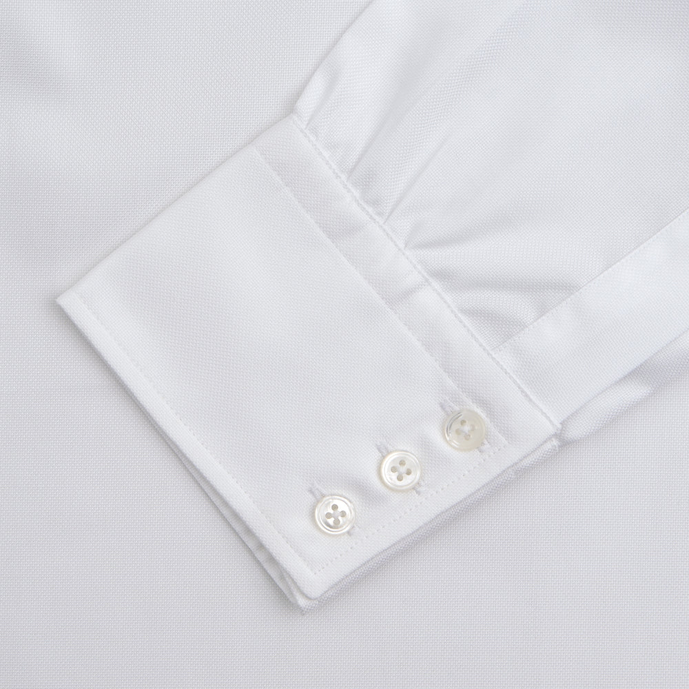 The Turnbull & Asser White Superfine Oxford Cotton Shirt features a T&A collar and 3-button cuffs, elegantly displayed against a light grey background.