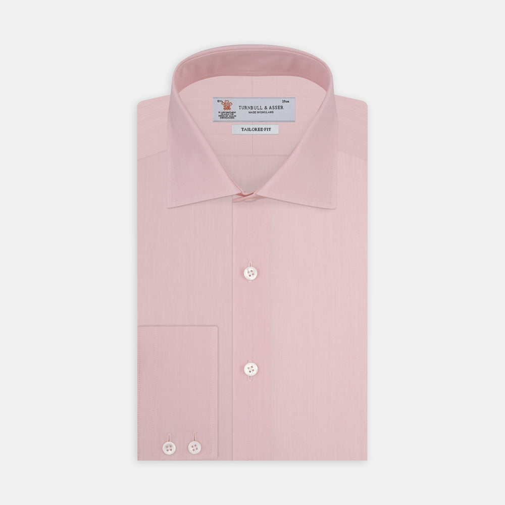 A neatly folded dark blue end-on-end Turnbull & Asser shirt with a T&A collar and 3-button cuffs, displayed against a plain white background. The label inside the collar is visible.