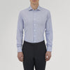 View 2 of product The Turnbull & Asser Tailored Fit Blue Fine Bengal Stripe Cotton Shirt features a Kent collar, double cuffs, and thin white stripes. Displayed neatly folded against a white background.