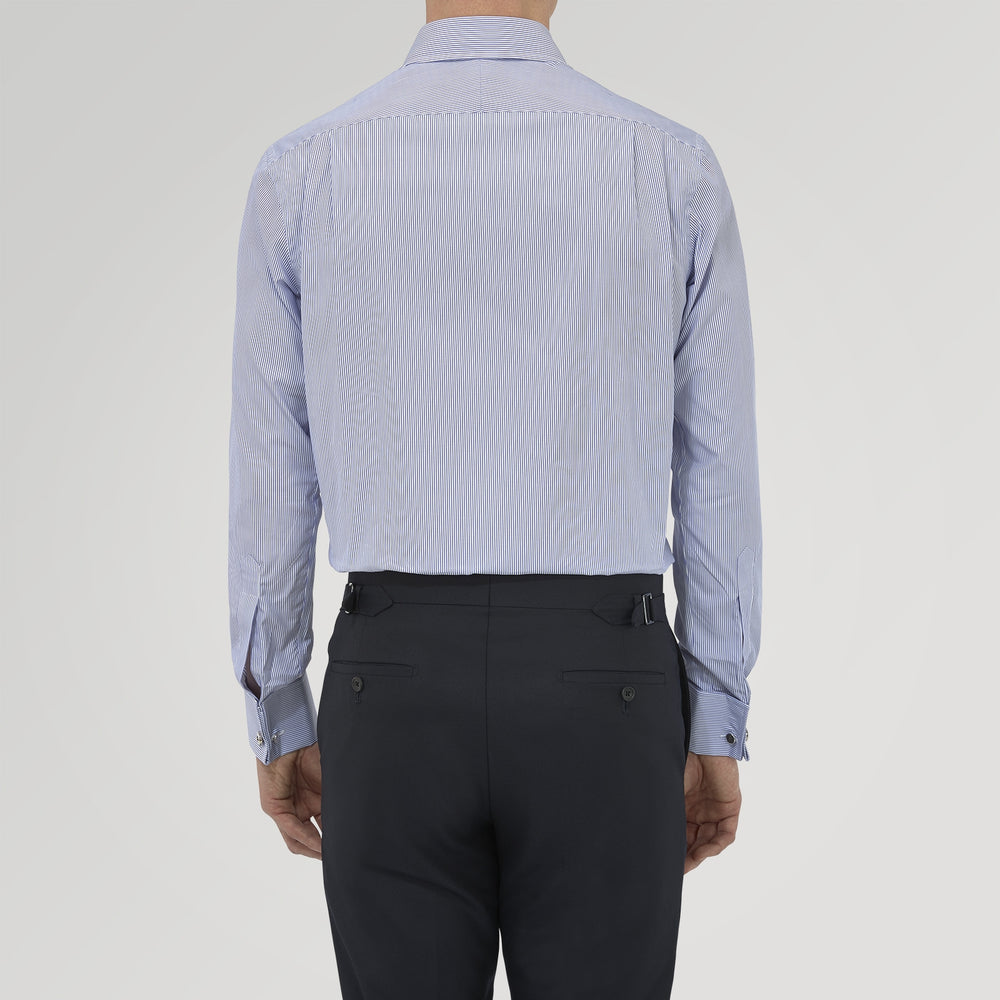 The Turnbull & Asser Tailored Fit Blue Fine Bengal Stripe Cotton Shirt features a Kent collar, double cuffs, and thin white stripes. Displayed neatly folded against a white background.