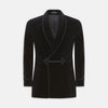 View 1 of product The Turnbull & Asser Black Double Breasted Velvet Smoking Jacket features a shawl collar, decorative frogging closure, and subtle piping on cuffs and edges, ideal for eveningwear and shown against a plain white background.