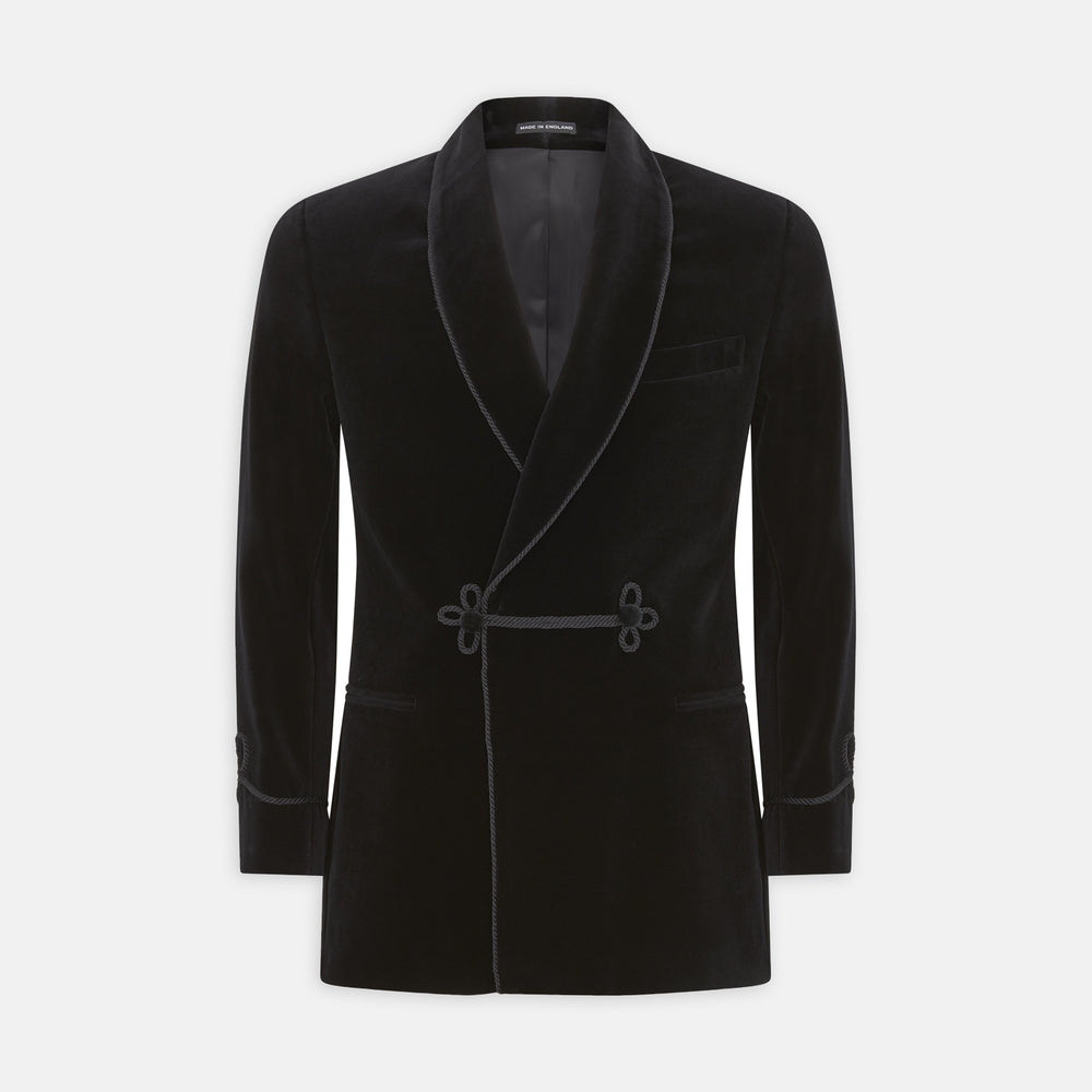 The Turnbull & Asser Black Double Breasted Velvet Smoking Jacket features a shawl collar, decorative frogging closure, and subtle piping on cuffs and edges, ideal for eveningwear and shown against a plain white background.