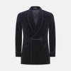 View 2 of product The Turnbull & Asser Navy Double Breasted Velvet Smoking Jacket features a shawl collar, corded closures on the front and cuffs, and a chest pocket, shown against a light gray background.