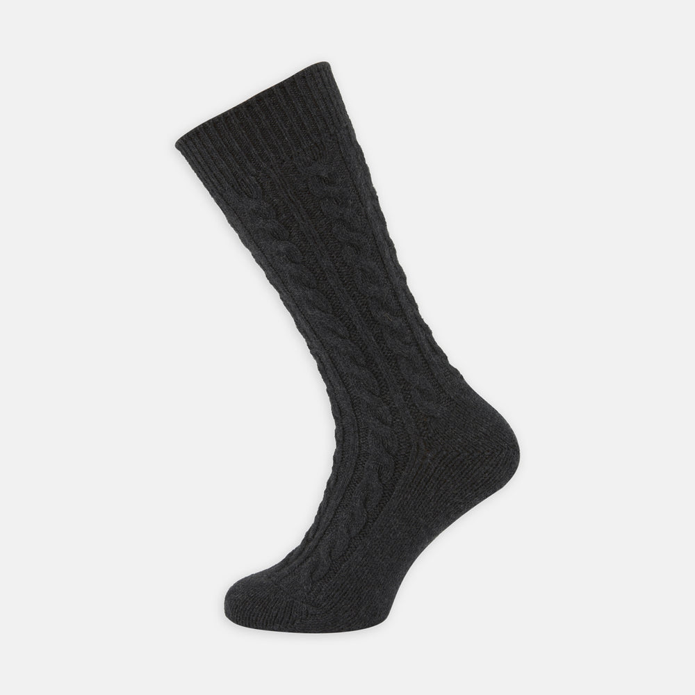 A Charcoal Cable Knit Cashmere Sock by Turnbull & Asser, featuring a ribbed cuff, is shown against a plain white background.