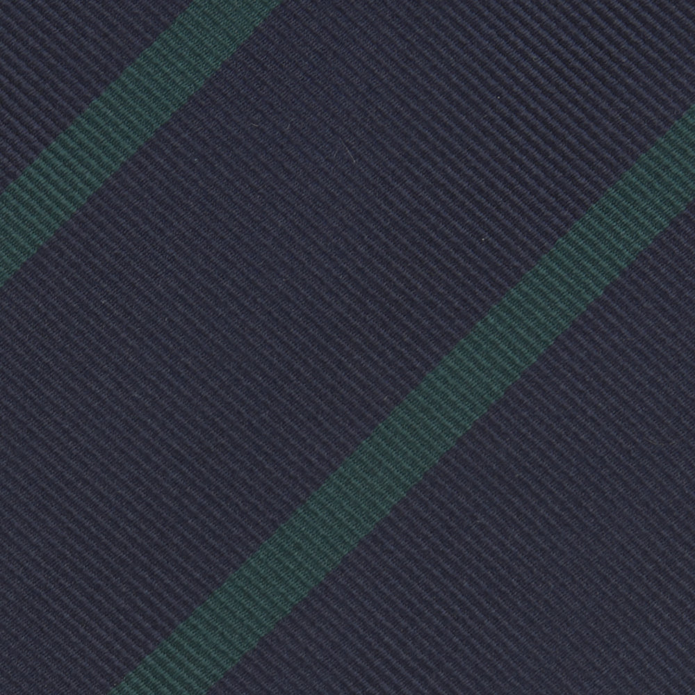 The Turnbull & Asser Navy and Green Blazer Stripe Repp Silk Tie features diagonal green stripes on navy silk, shown rolled at one end against a white background.