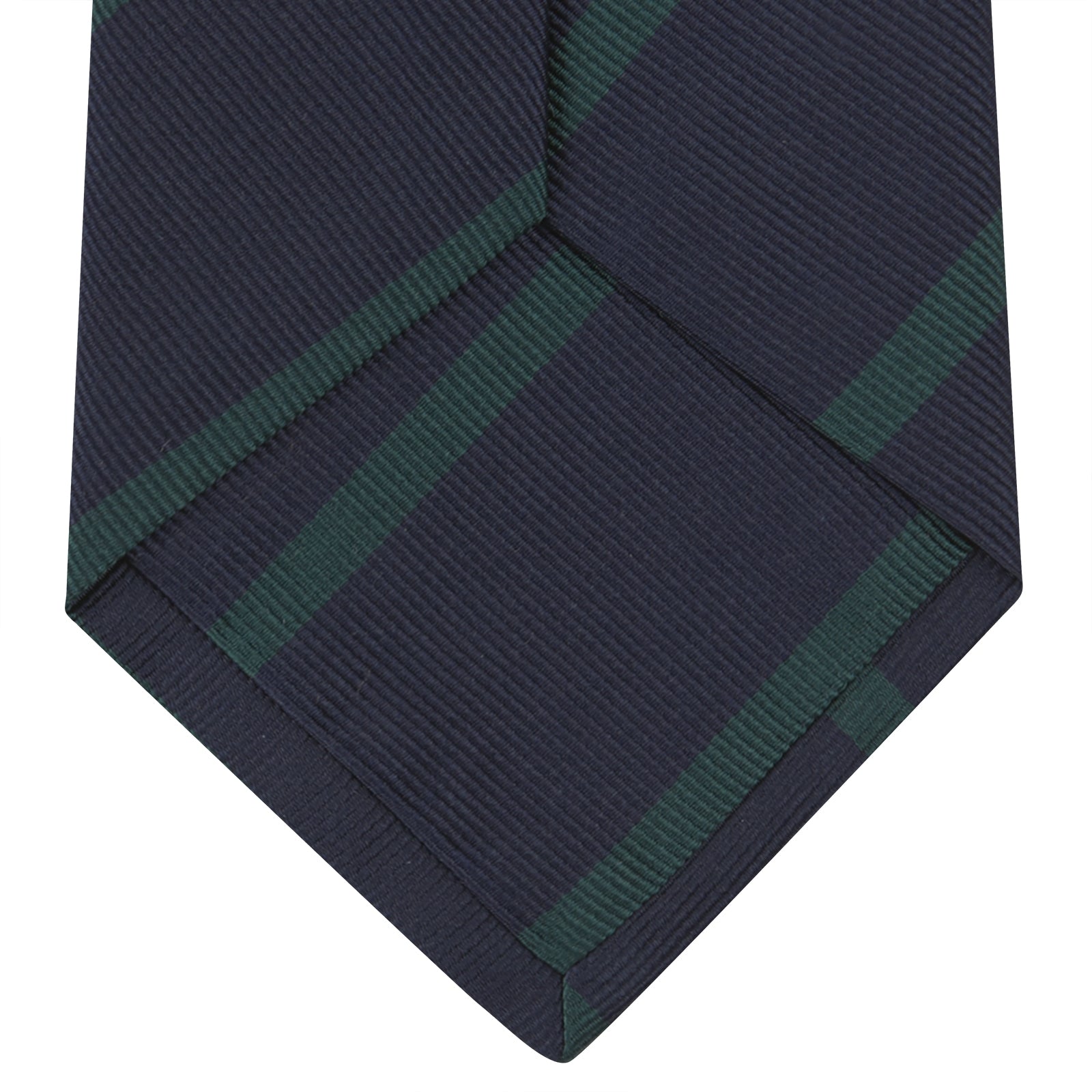 View 4 of product The Turnbull & Asser Navy and Green Blazer Stripe Repp Silk Tie features diagonal green stripes on navy silk, shown rolled at one end against a white background.