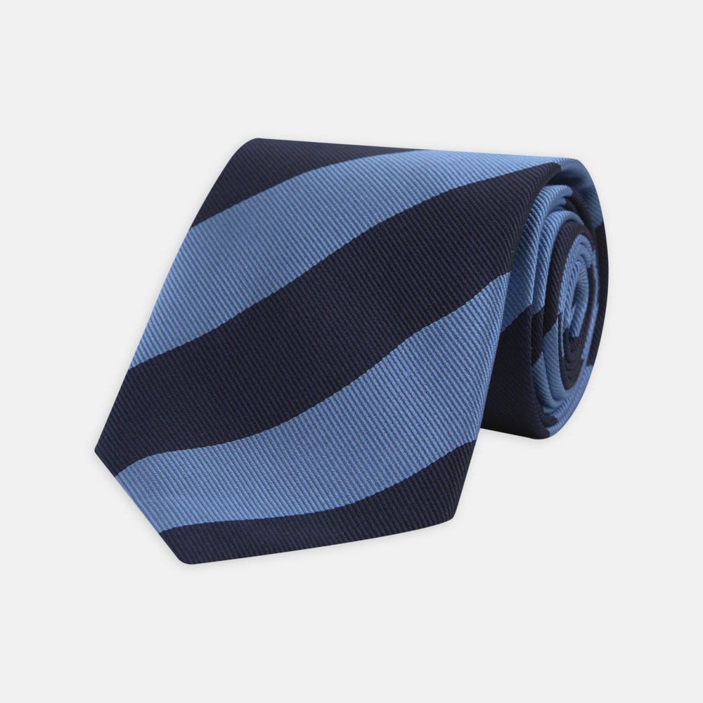 The Turnbull & Asser Navy and Blue Block Stripe Repp Silk Tie features wide navy and blue diagonal stripes on luxurious textured silk, elegantly presented against a white background.