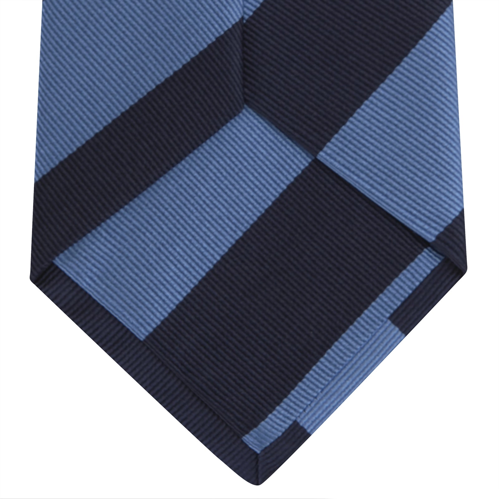View 4 of product The Turnbull & Asser Navy and Blue Block Stripe Repp Silk Tie features wide navy and blue diagonal stripes on luxurious textured silk, elegantly presented against a white background.