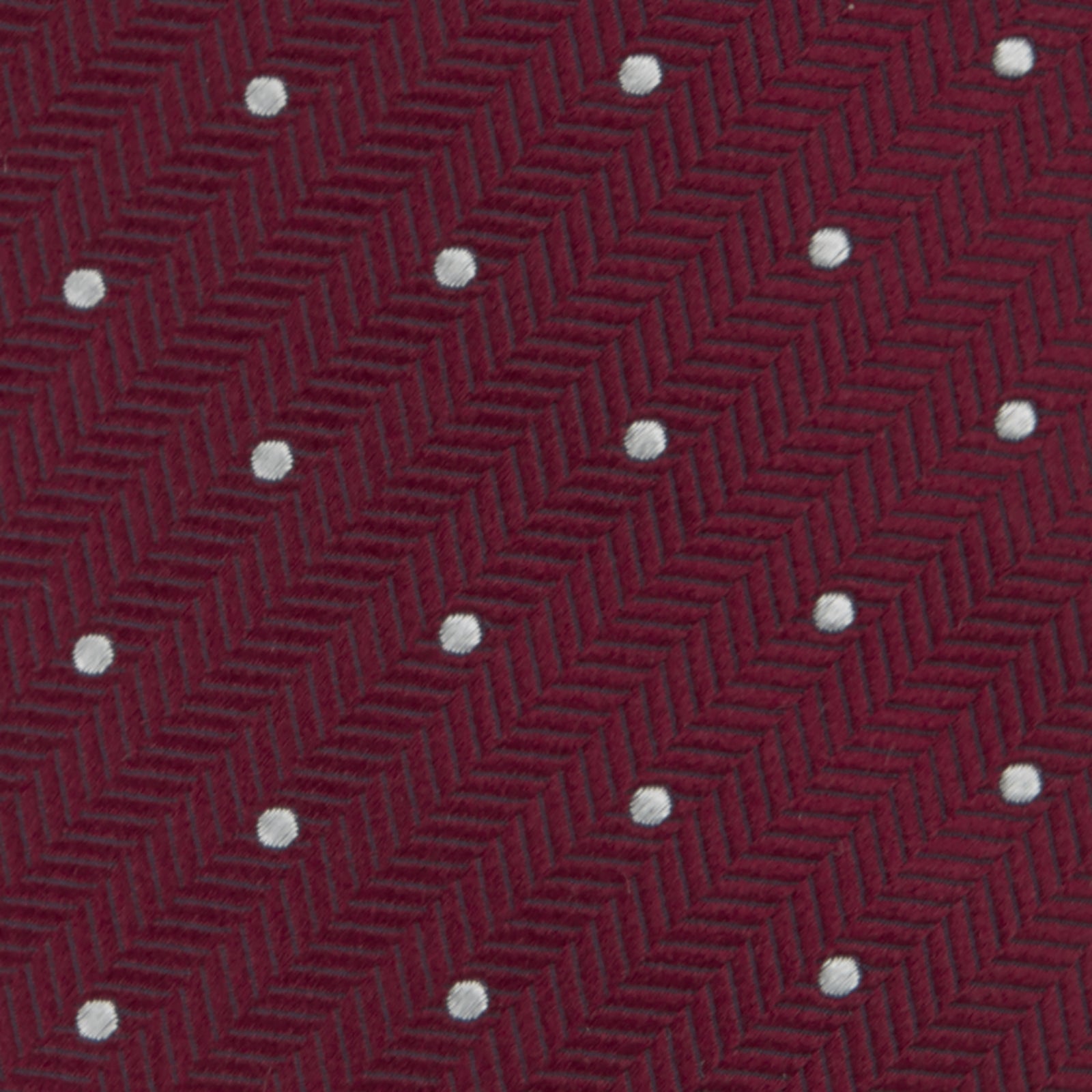 View 3 of product The Turnbull & Asser Burgundy and White Small Spot Herringbone Silk Tie, crafted from fine English silk, is shown rolled up on a plain white background.
