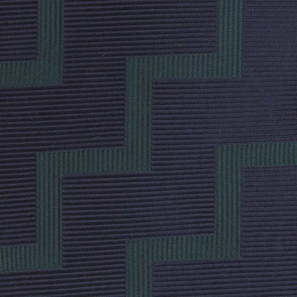 A modern essential, the Turnbull & Asser Navy and Forest Green Striped Zigzag Silk Tie features a bold navy and forest green zigzag pattern, elegantly displayed rolled on a crisp white background.