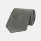 The Turnbull & Asser Grey Floral Spot Silk Tie, shown rolled up on a white background, features a classic black and white spot pattern.