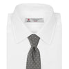 View 2 of product The Turnbull & Asser Grey Floral Spot Silk Tie, shown rolled up on a white background, features a classic black and white spot pattern.
