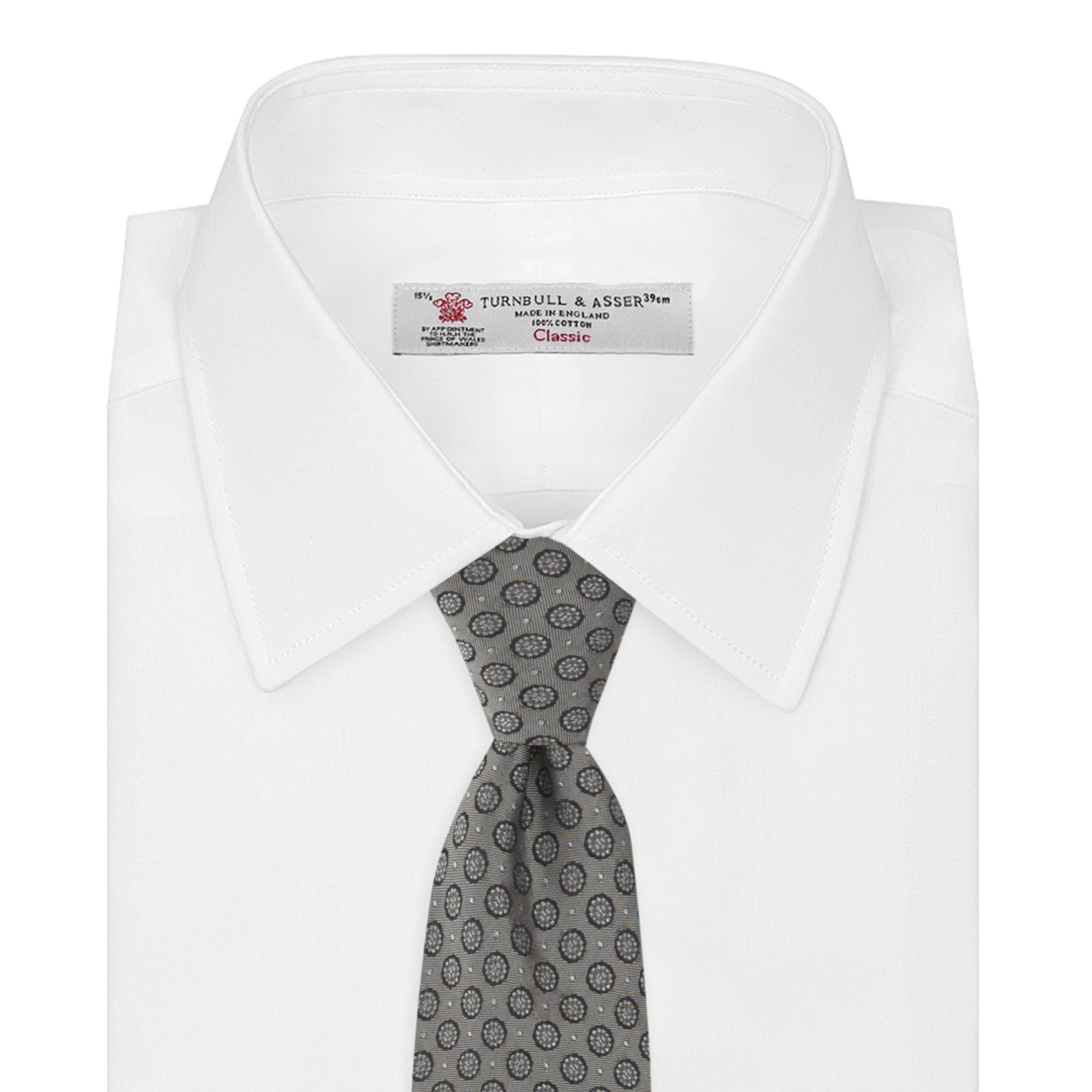 View 2 of product The Turnbull & Asser Grey Floral Spot Silk Tie, shown rolled up on a white background, features a classic black and white spot pattern.
