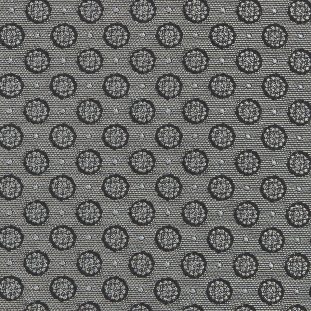 The Turnbull & Asser Grey Floral Spot Silk Tie, shown rolled up on a white background, features a classic black and white spot pattern.