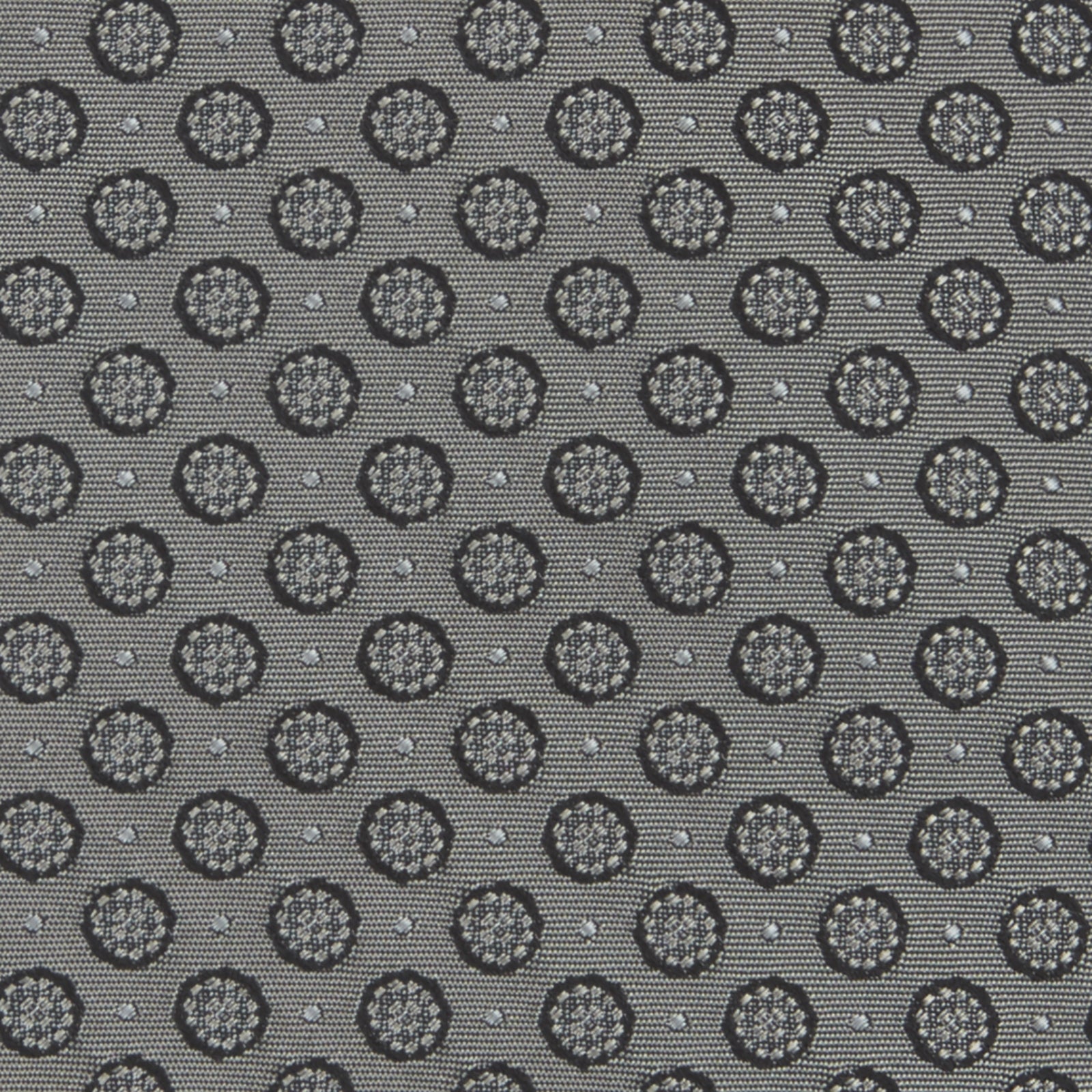 View 3 of product The Turnbull & Asser Grey Floral Spot Silk Tie, shown rolled up on a white background, features a classic black and white spot pattern.