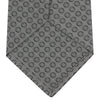 View 4 of product The Turnbull & Asser Grey Floral Spot Silk Tie, shown rolled up on a white background, features a classic black and white spot pattern.
