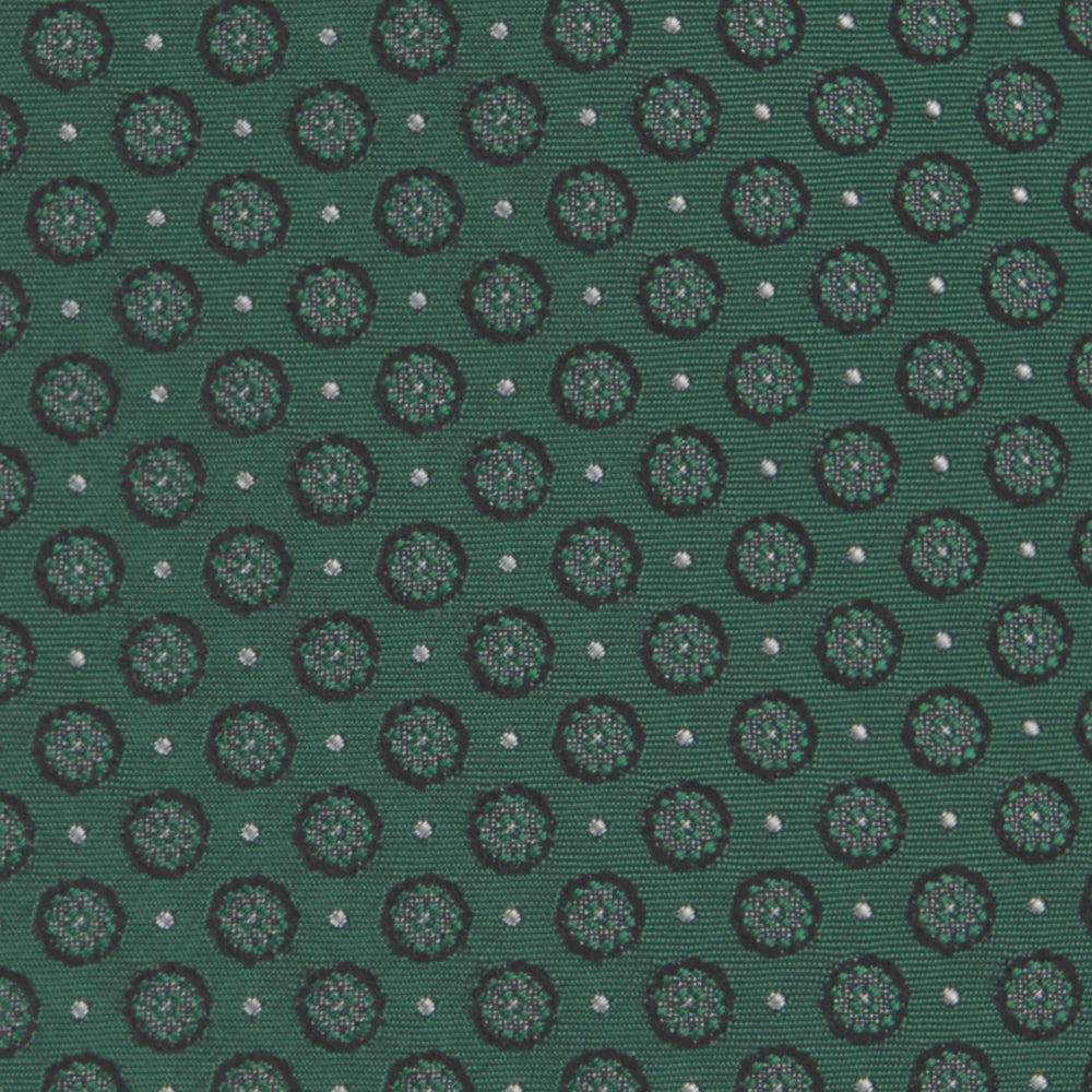 The Turnbull & Asser Green Floral Spot Silk Tie features small, light-colored circular dots on a classic green silk background—ideal for dressing up your favorite office shirt. Displayed rolled on a plain white backdrop.