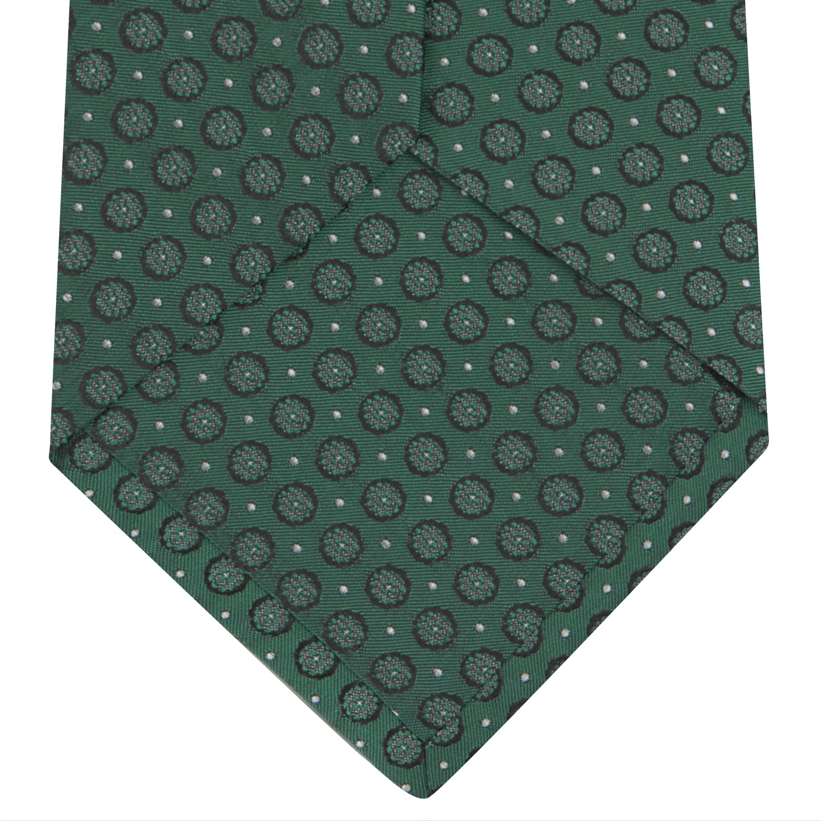 View 4 of product The Turnbull & Asser Green Floral Spot Silk Tie features small, light-colored circular dots on a classic green silk background—ideal for dressing up your favorite office shirt. Displayed rolled on a plain white backdrop.