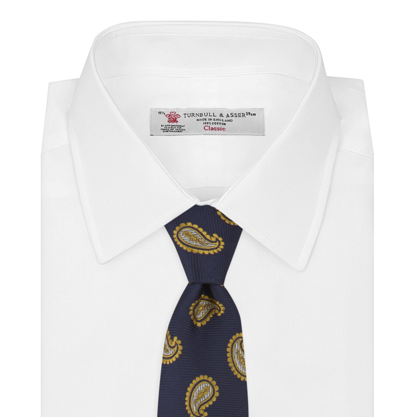 View 2 of product The Turnbull & Asser Navy and Gold Floating Paisley Silk Tie features a repeating yellow and white paisley pattern, shown rolled with the pointed end facing forward against a white background.