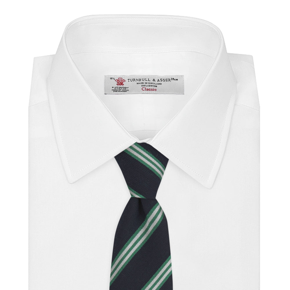 The Turnbull & Asser Navy, Green and White Multi Repp Stripe Silk Tie features elegant diagonal stripes, making it a classic accessory for any occasion. Shown rolled on a white background.