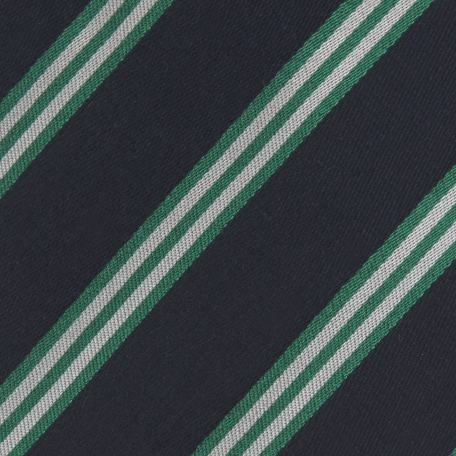 View 3 of product The Turnbull & Asser Navy, Green and White Multi Repp Stripe Silk Tie features elegant diagonal stripes, making it a classic accessory for any occasion. Shown rolled on a white background.