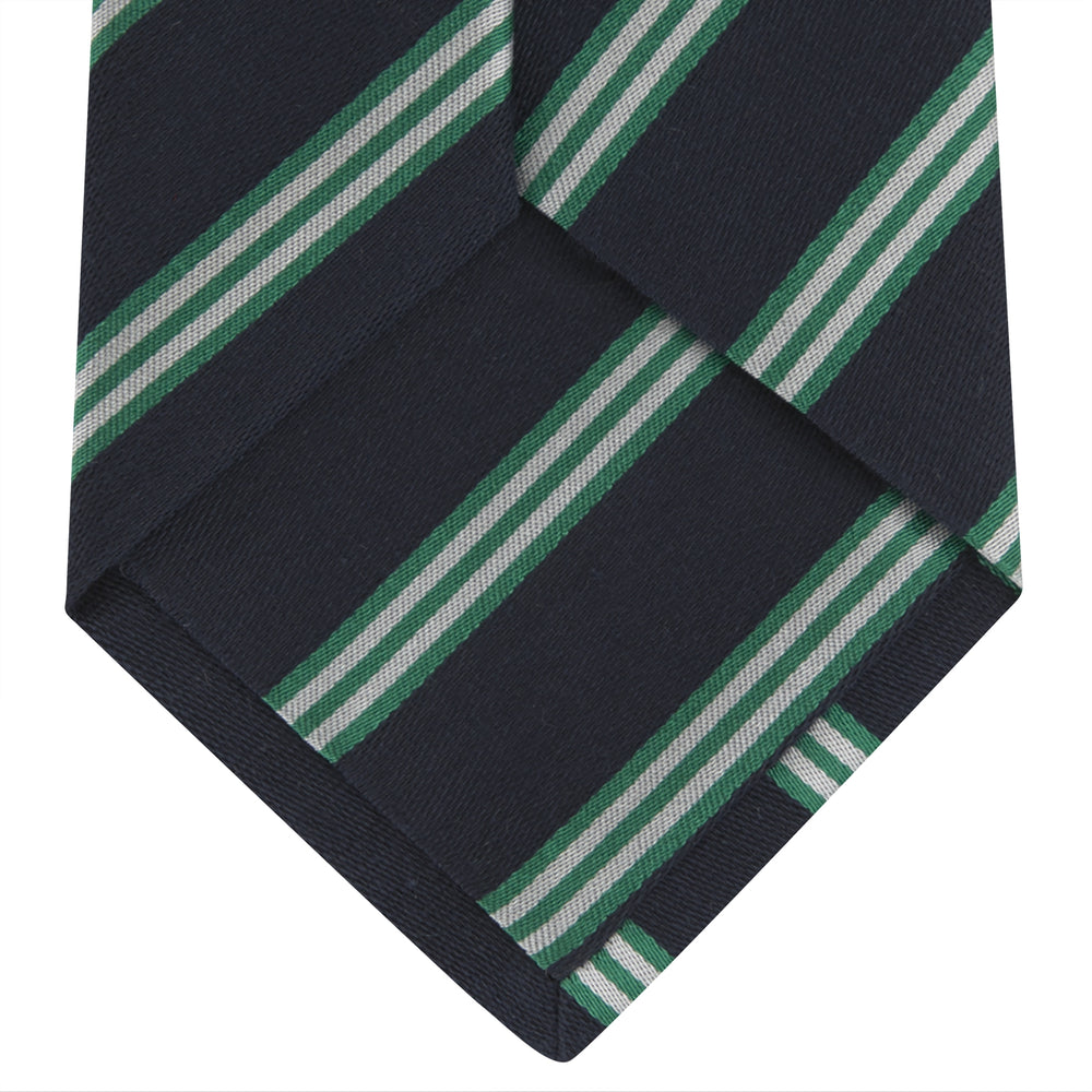 The Turnbull & Asser Navy, Green and White Multi Repp Stripe Silk Tie features elegant diagonal stripes, making it a classic accessory for any occasion. Shown rolled on a white background.