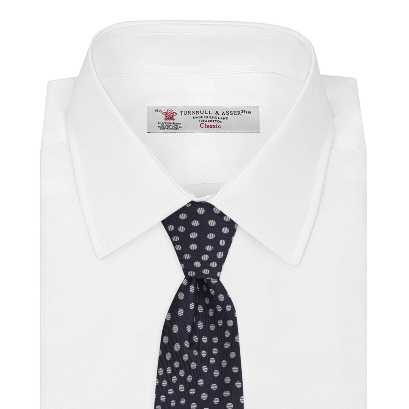 View 2 of product The Turnbull & Asser Navy and White Paint Spot Silk Tie features evenly spaced white spots on classic navy, shown rolled up on a white background—ideal for complementing your favorite office shirt.