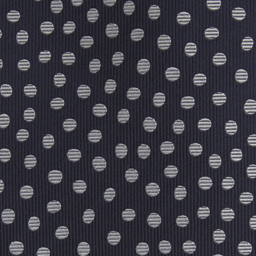 The Turnbull & Asser Navy and White Paint Spot Silk Tie features evenly spaced white spots on classic navy, shown rolled up on a white background—ideal for complementing your favorite office shirt.