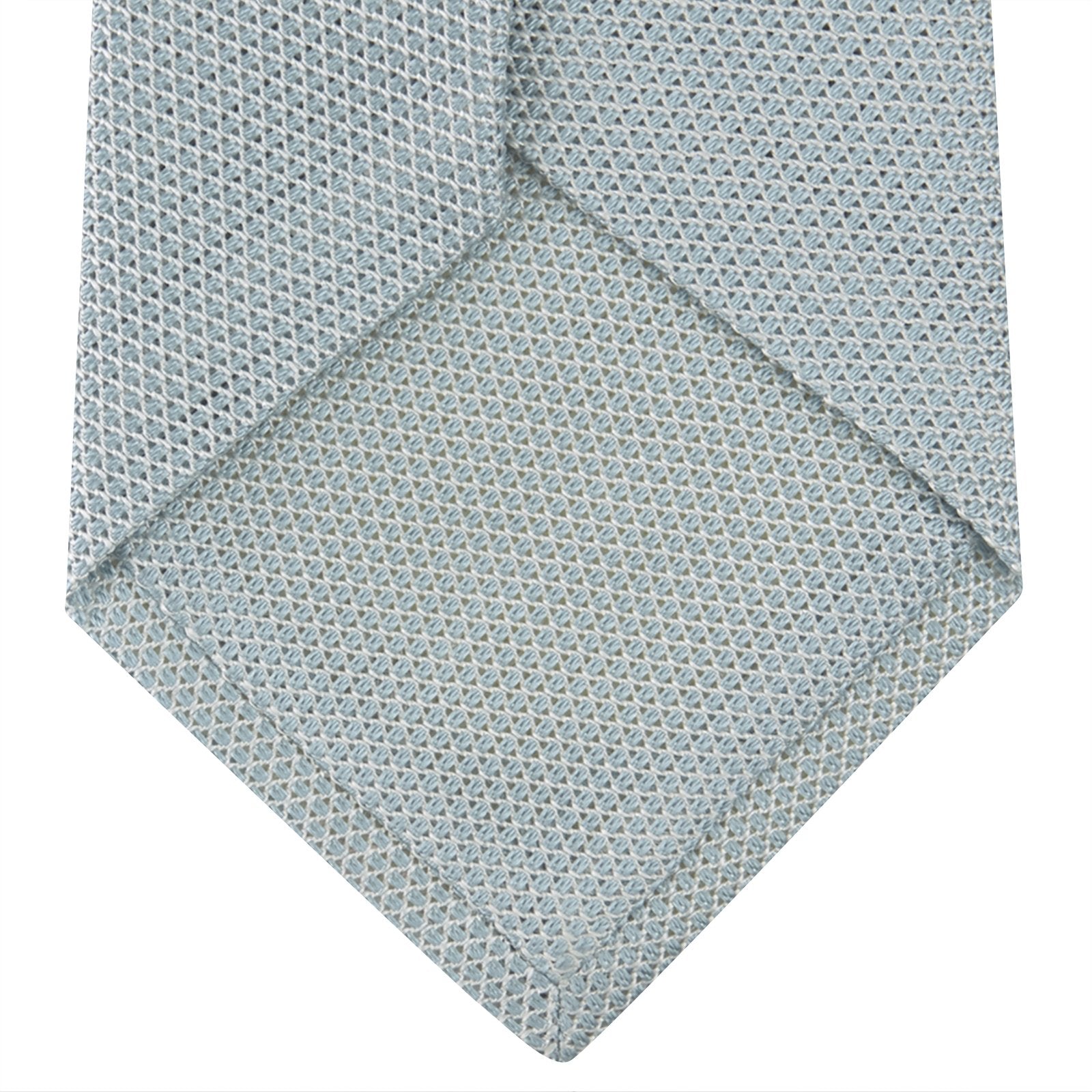 View 4 of product A neatly rolled Turnbull & Asser Light Blue Grenadine Silk Tie, featuring a subtle textured weave, displayed on a white background.