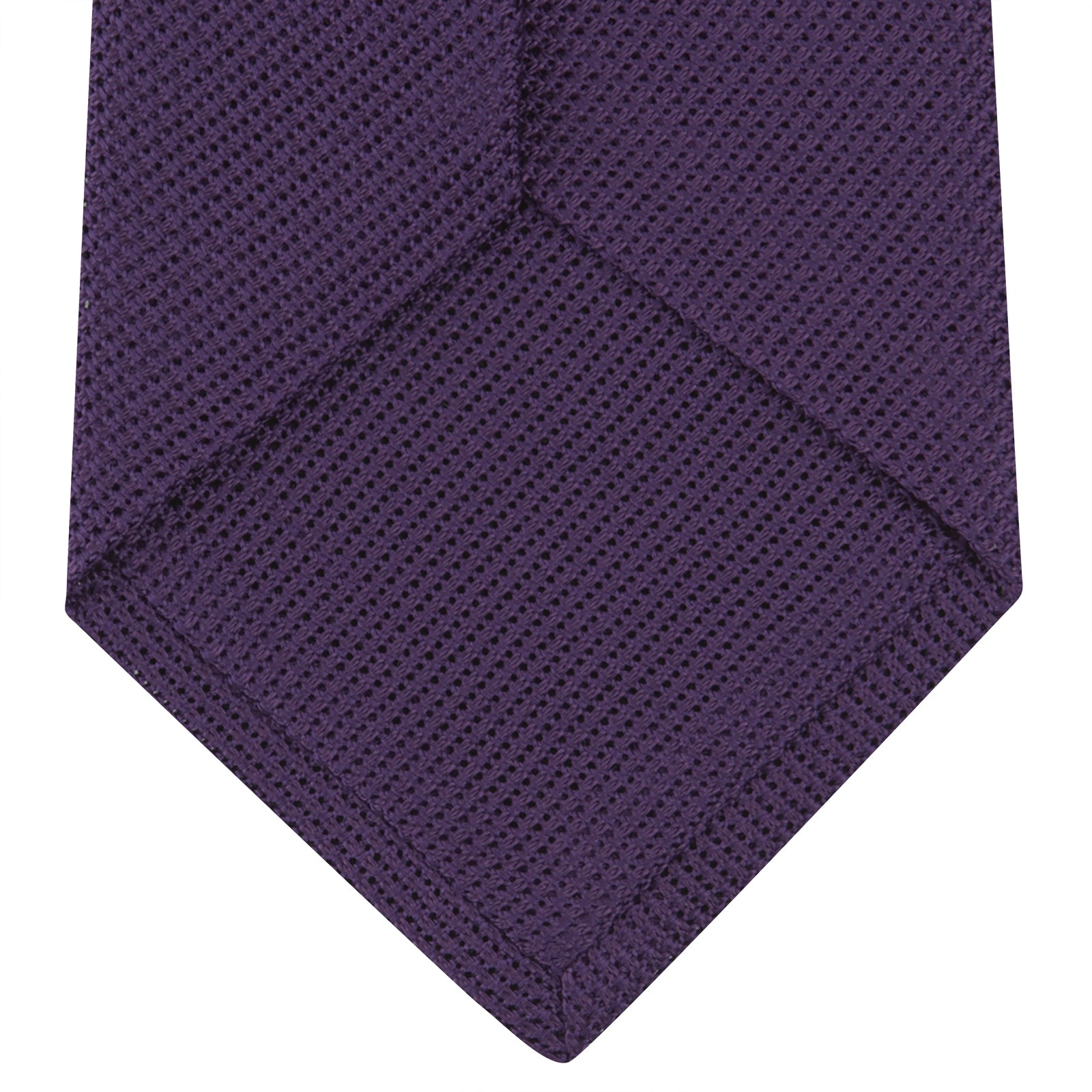 View 4 of product The Turnbull & Asser Plum Grenadine Silk Tie, featuring a textured grenadine weave, is shown rolled up on a plain white background.