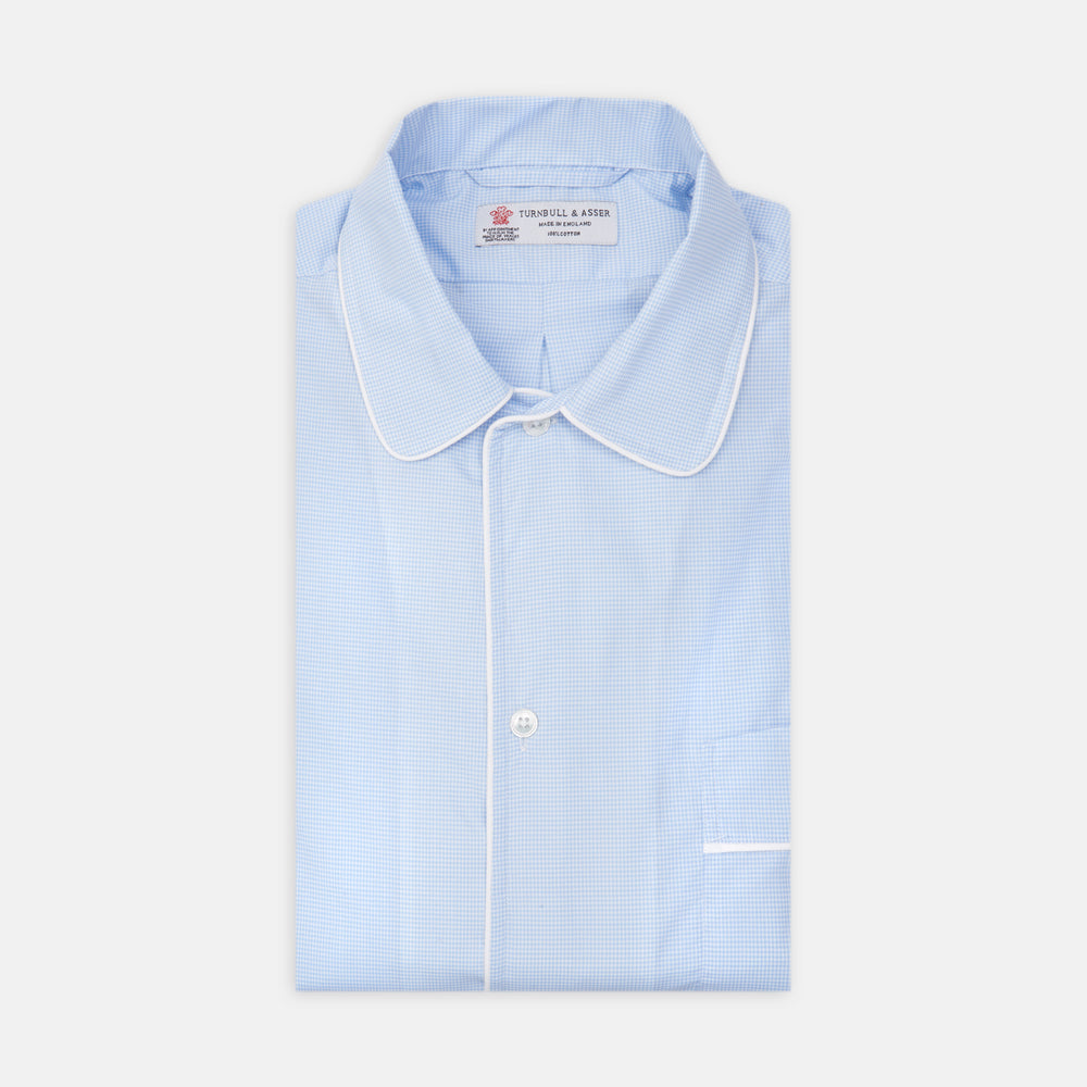 The Turnbull & Asser Sky Blue Micro-Check Cotton Nightshirt features white piping on the collar, button placket, and pocket, a subtle check pattern, and a visible label inside the collar.