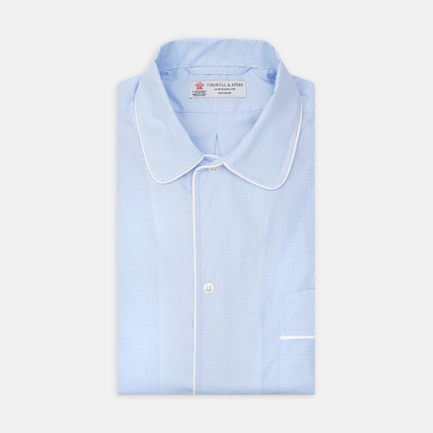 View 1 of product The Turnbull & Asser Sky Blue Micro-Check Cotton Nightshirt features white piping on the collar, button placket, and pocket, a subtle check pattern, and a visible label inside the collar.