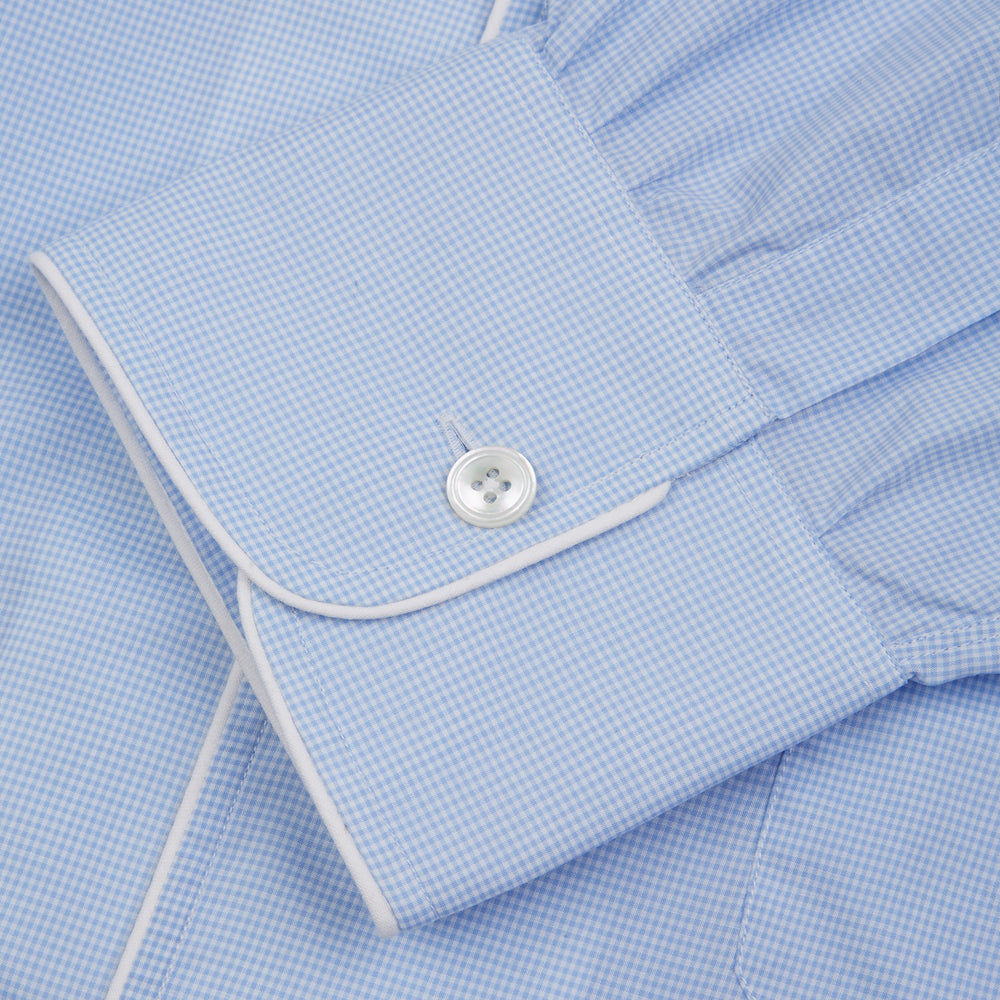 The Turnbull & Asser Sky Blue Micro-Check Cotton Nightshirt features white piping on the collar, button placket, and pocket, a subtle check pattern, and a visible label inside the collar.
