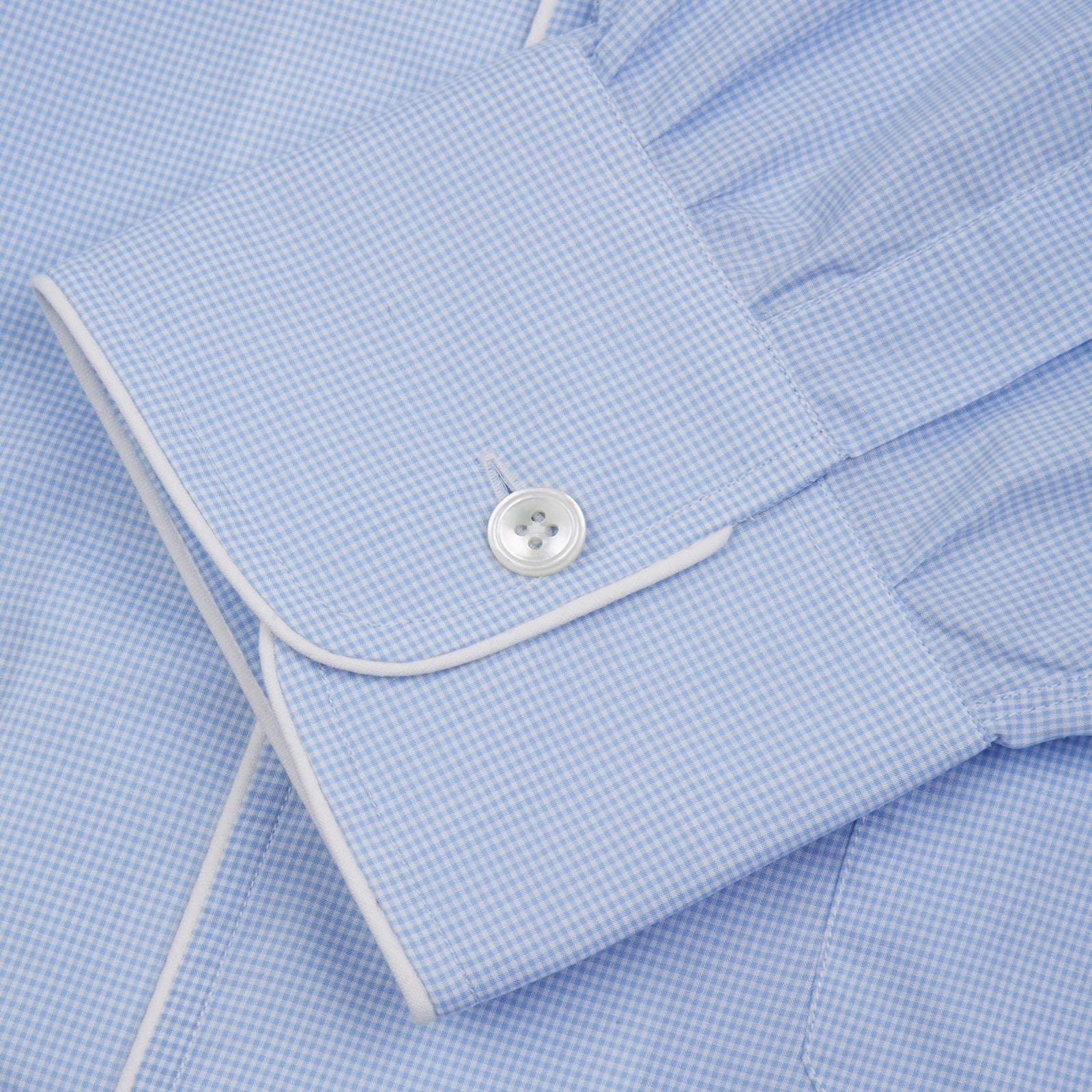 View 4 of product The Turnbull & Asser Sky Blue Micro-Check Cotton Nightshirt features white piping on the collar, button placket, and pocket, a subtle check pattern, and a visible label inside the collar.