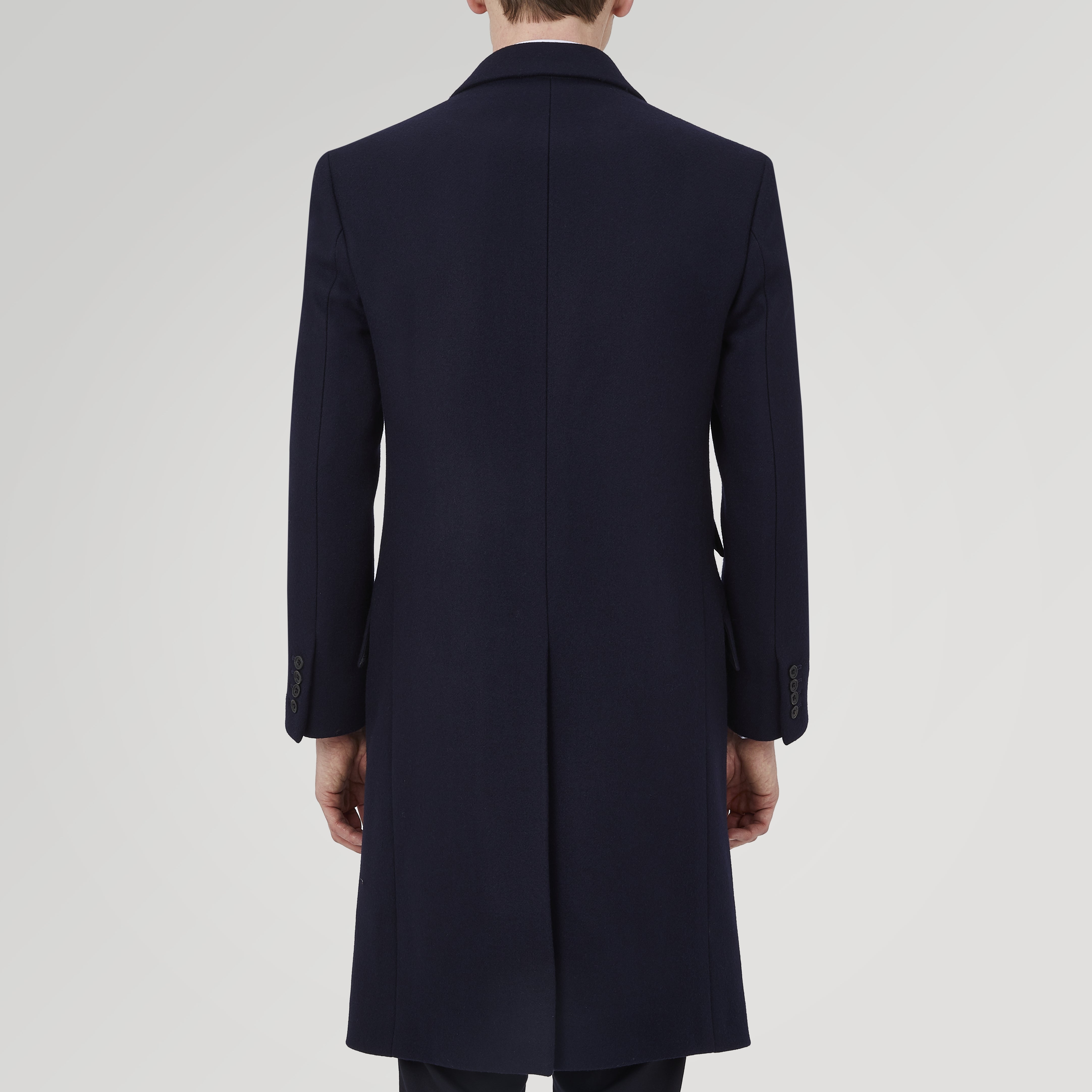 View 3 of product The Turnbull & Asser Navy Lambswool Joseph Overcoat, a men's knee-length coat with notched lapels, a single-breasted front, and three flap pockets per side, is shown against a plain white background.