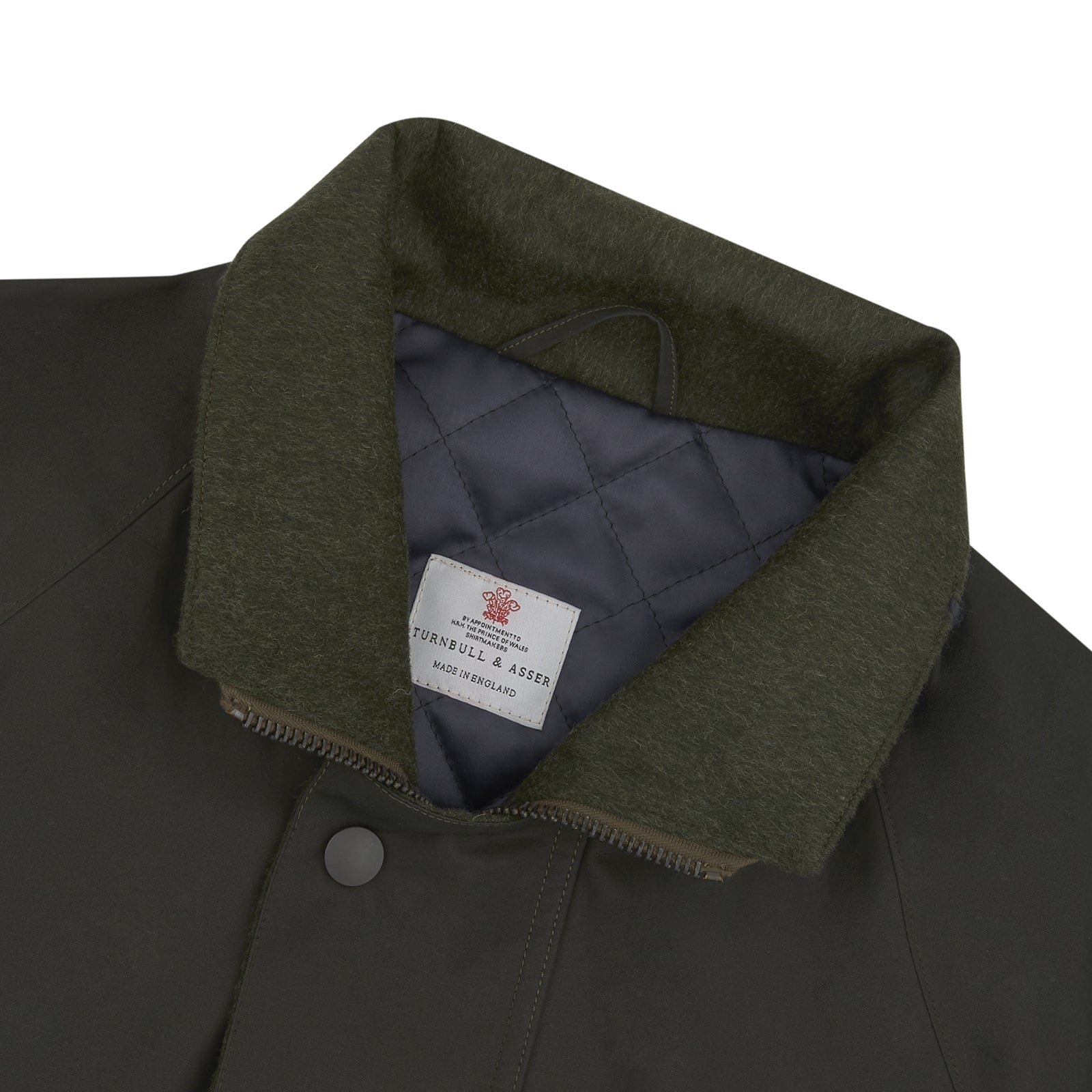 View 6 of product The Turnbull & Asser Dark Green Waxed Cotton Field Coat features a straight fit, button-up front, two large bottom flap pockets, slanted chest pockets, and a contrasting collar. Shown against a plain white background.