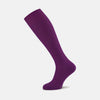 View 1 of product A single Magenta Long Merino Wool Sock by Turnbull & Asser is displayed side-on against a neutral background, showcasing its ribbed design, visible foot and calf, and representing the comfort and style of luxury men's socks.